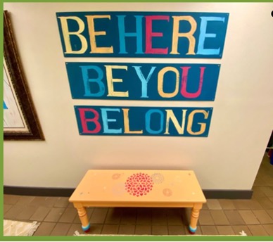 A sign that reads "Be Here. Be You. Belong" at Juliette Fowler's The Ebby House.